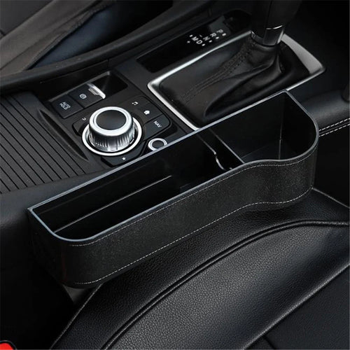 Car interior with a black organizer placed on the center console.