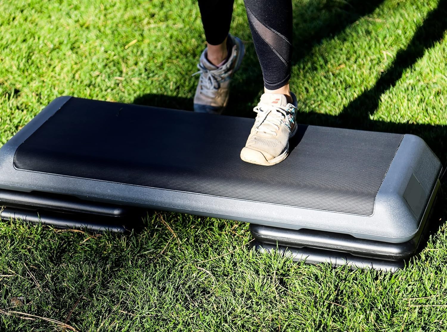 Step platform being used outdoors on grass