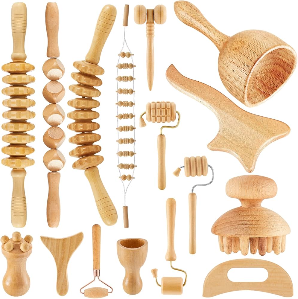 Collection of various wooden massage tools on a white background