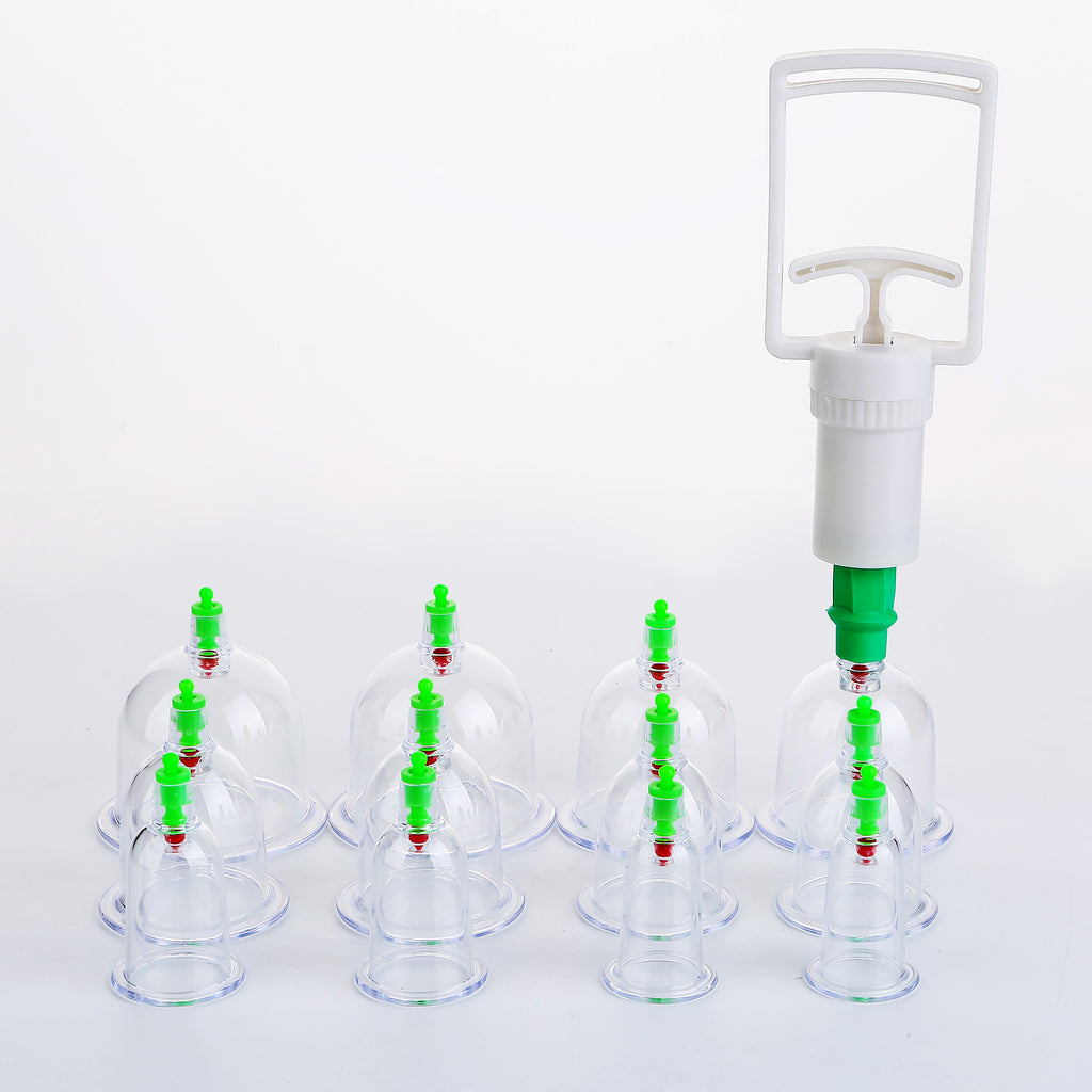 Cupping therapy set with clear cups and green handles on a white background